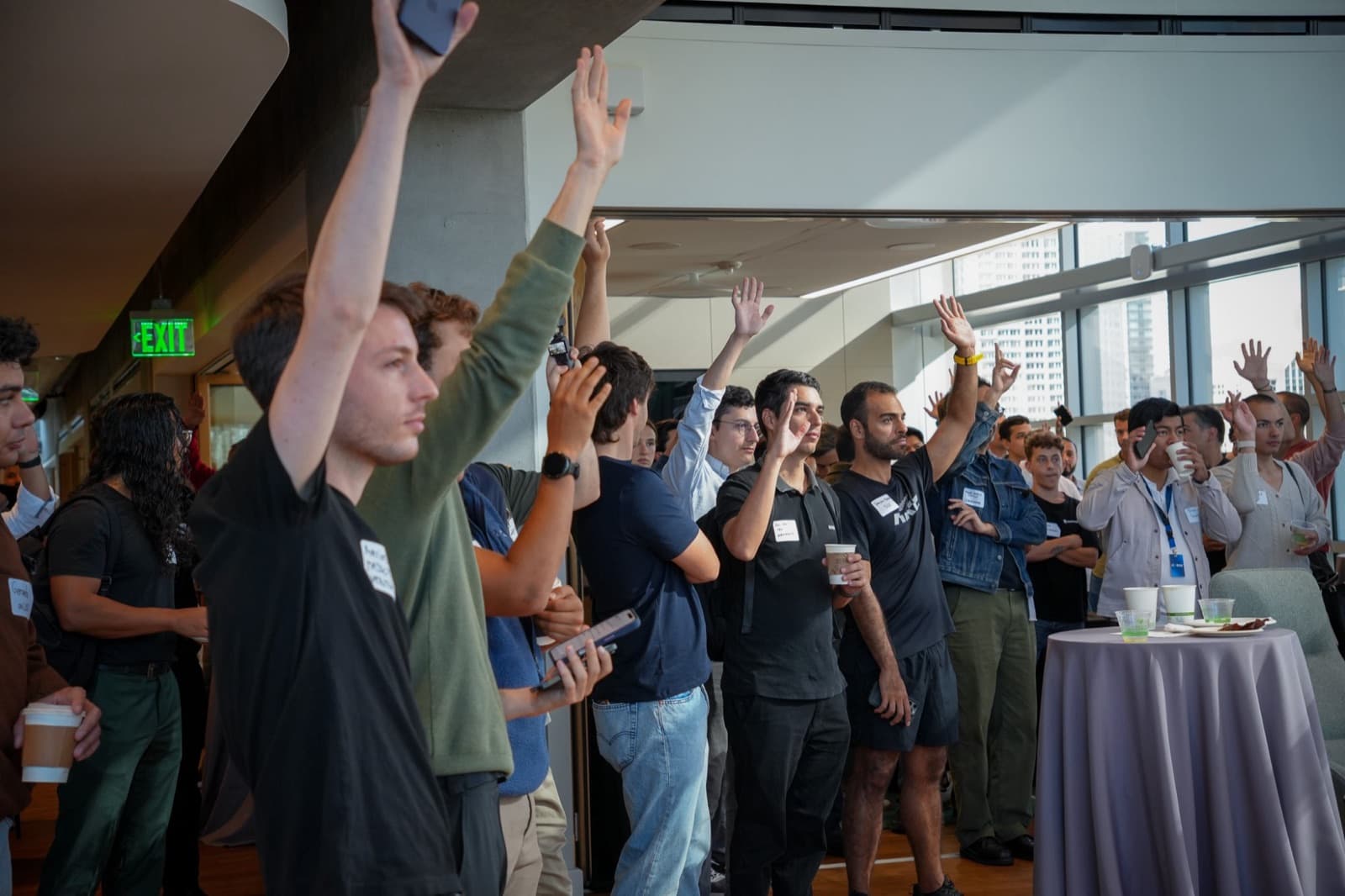 Founders raising hands at a Pygma session